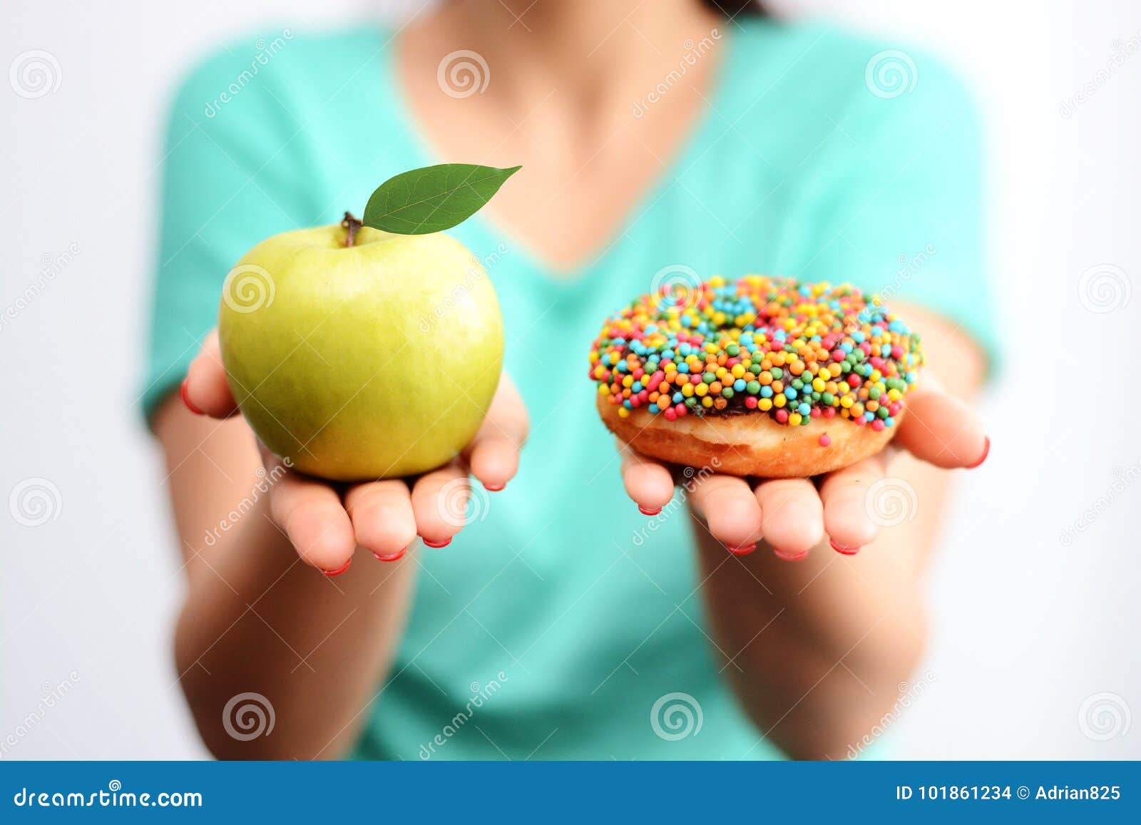 itÃ¢â¬â¢s hard to choose healthy food concept, with woman hand holding an green apple and a calorie bomb donut
